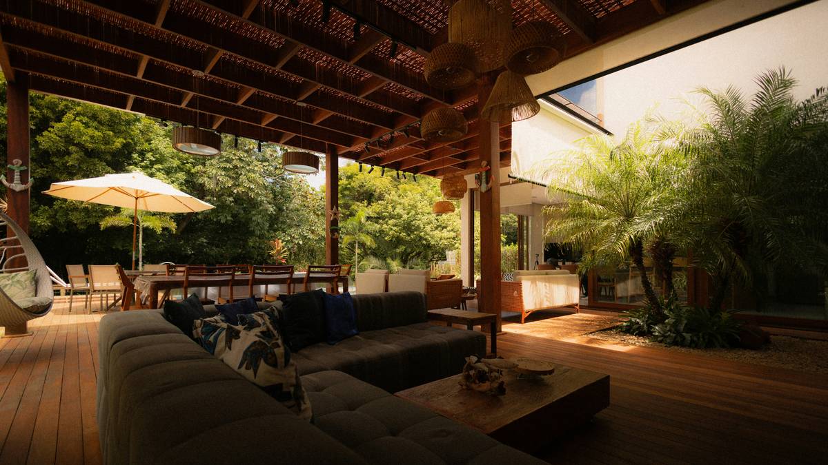pergola style design ideas featuring a teak dining set under a louvered pergola with string lighting