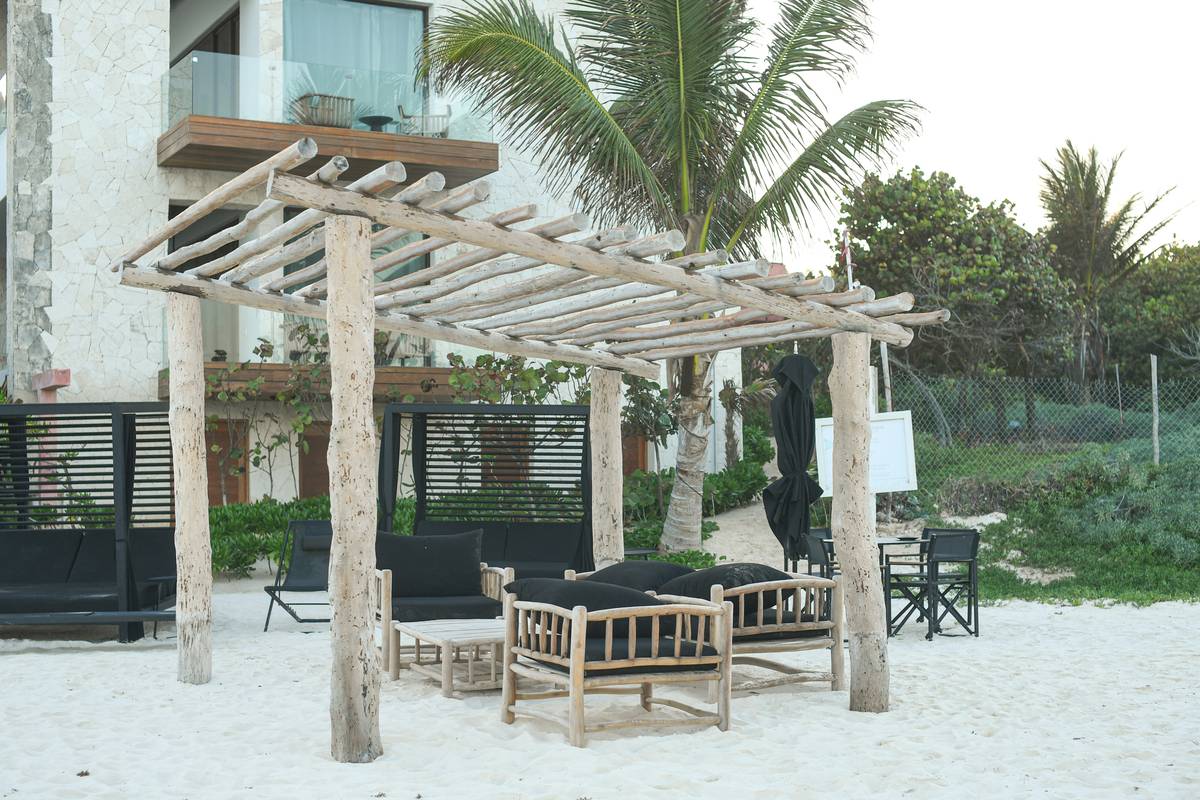 Modular outdoor pergola decorating ideas with weather-resistant sectional sofa under slatted canopy